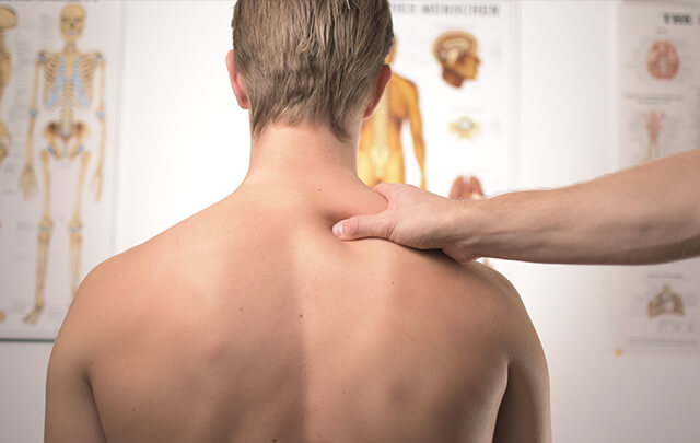 Man from behind with doctors hand on shoulder