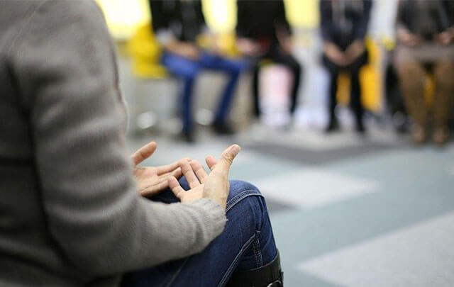 Woman participating in group therapy treatment program